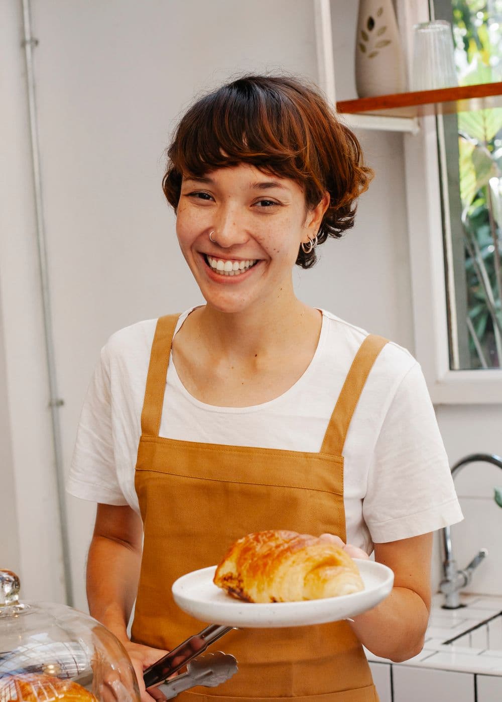 Small business baker welcoming a customer