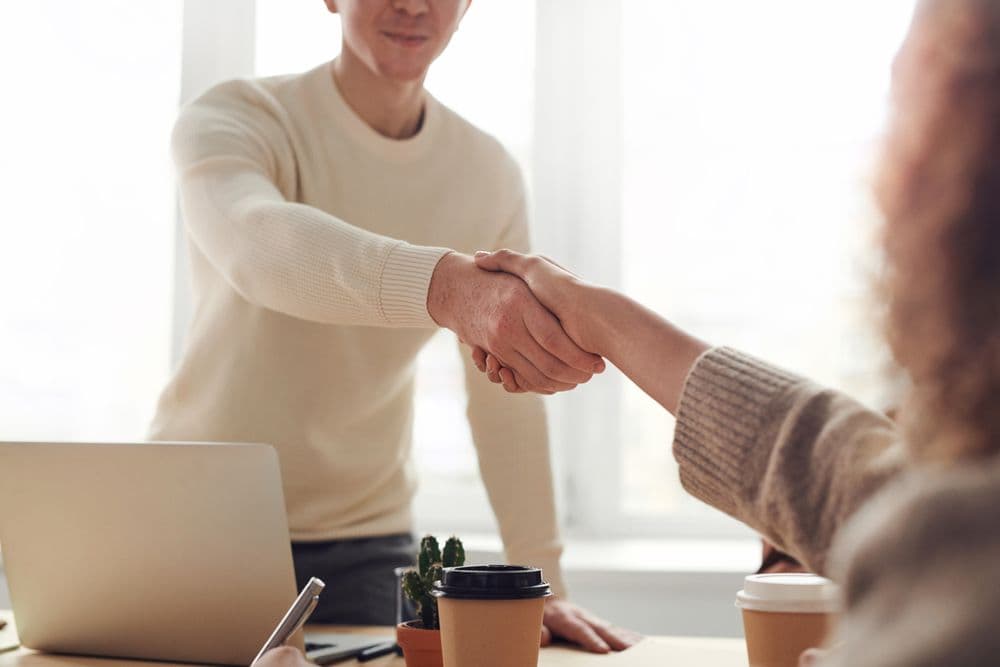 Agency professionals meeting across a workspace